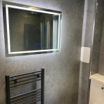 LED mirror in a panelled bathroom